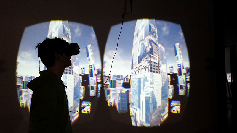 Marc Lee’s 10.000 Moving Cities VR installation at ZKM Karlsruhe, with networked city imagery mapped onto virtual architecture.