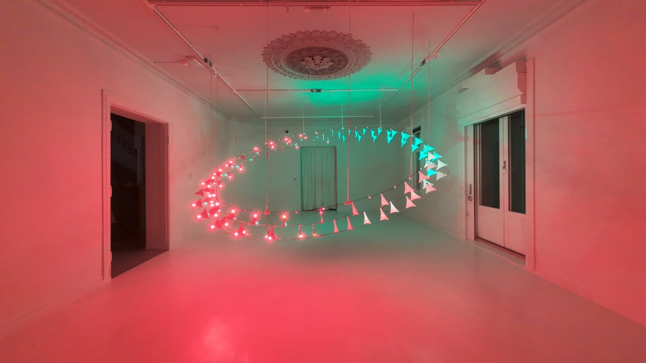 Boucle de modules lumineux suspendus dans une salle.