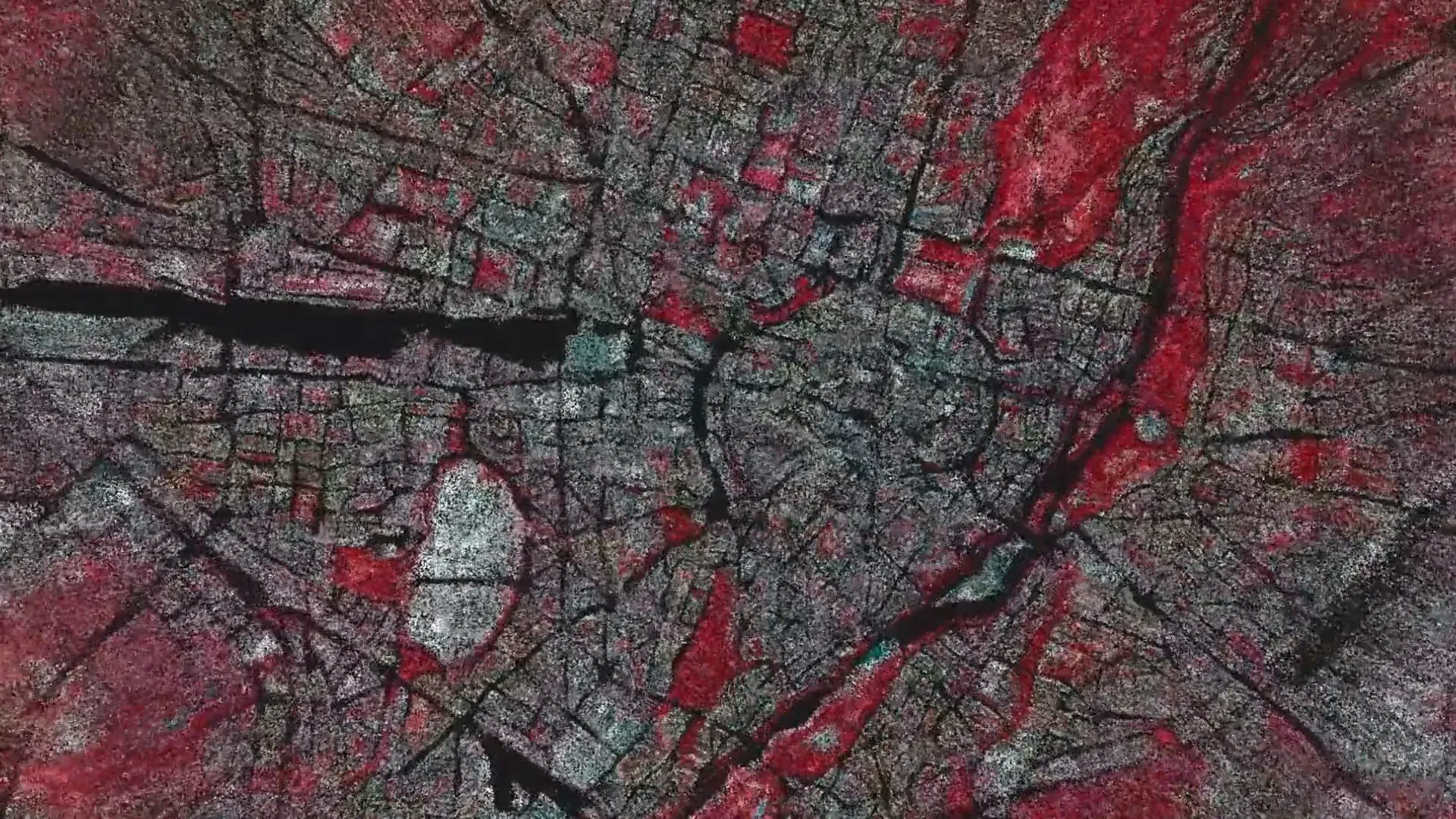 Détail de Data Soil : une carte de Munich se décompose en particules grises et rouges autour du tracé sombre de la rivière et des rues.